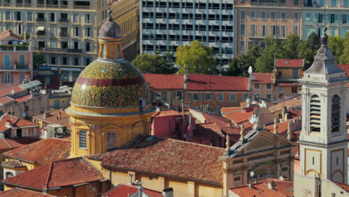 Video - Aerial drone view of Nice Cathedral with its colorful tiled dome, historic bell tower, and surrounding terracotta rooftops of the Old Town