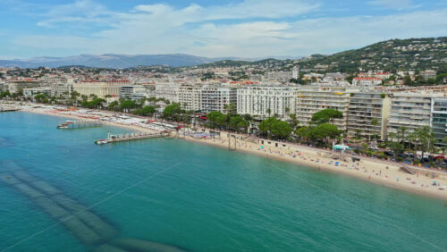 Video - Aerial drone view of the sandy beach with turquoise water and curved shoreline, Cannes, France