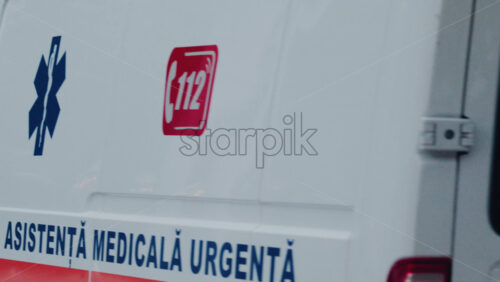 Video - Chisinau, Moldova - October 1, 2025: Emergency ambulance driving through a city street with flashing blue lights during dusk