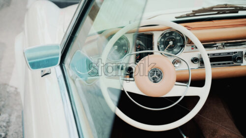 Video - Cannes, France - October 13, 2025: Close up view of a classic Mercedes convertible car interior with beige leather seats and chrome dashboard details
