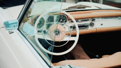 Video - Cannes, France - October 13, 2025: Close up view of a classic Mercedes convertible car interior with beige leather seats and chrome dashboard details
