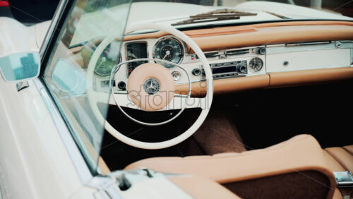 Video - Cannes, France - October 13, 2025: Close up view of a classic Mercedes convertible car interior with beige leather seats and chrome dashboard details