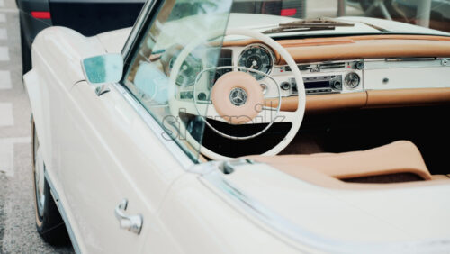 Video - Cannes, France - October 13, 2025: Close up view of a classic Mercedes convertible car interior with beige leather seats and chrome dashboard details