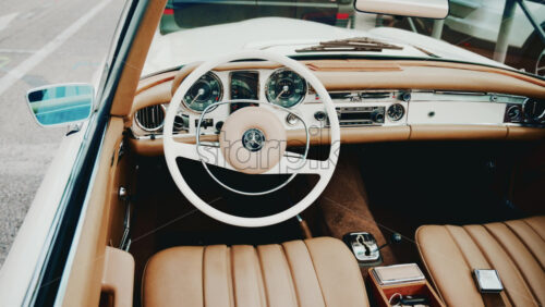 Video - Cannes, France - October 13, 2025: Close up view of a classic Mercedes convertible car interior with beige leather seats and chrome dashboard details