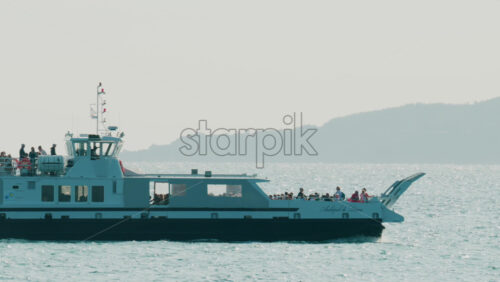 Video - Cannes, France - October 3, 2025: Passenger ferry crossing bright turquoise waters under clear sky