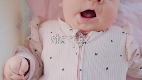 Video - Close up of baby's lips and cheeks in warm pastel light