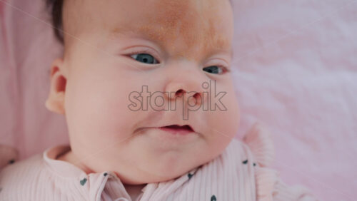 Video - Close up of baby's lips and cheeks in warm pastel light