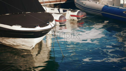 Video - Close up of a boat's bow surrounded by sea foam in sunlight