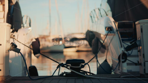 Video - Close up of a white yacht reflecting sunlight on calm water
