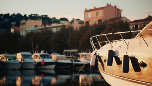 Video - Close up of a white yacht reflecting sunlight on calm water