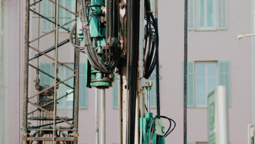 Video - Close up of industrial drilling equipment with hydraulic cables and metal framework