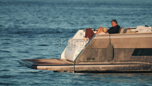 Video - Cannes, France - October 16, 2025: Side view of a sleek metallic yacht reflecting sunlight on calm blue water