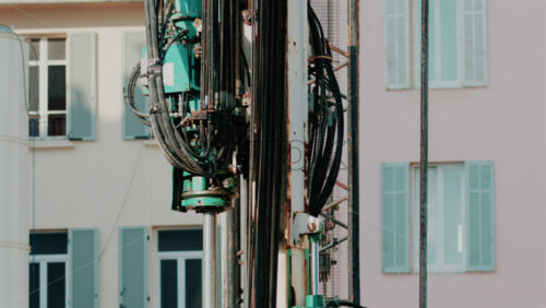 Video - Close up of industrial drilling equipment with hydraulic cables and metal framework