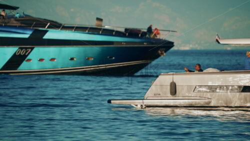 Video - Cannes, France - October 16, 2025: Two modern yachts anchored on calm blue water during golden hour