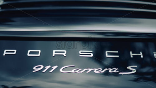 Video - Cannes, France - October 16, 2025: Close up of the rear of a Porsche 911 Carrera S luxury sports car with metallic reflections