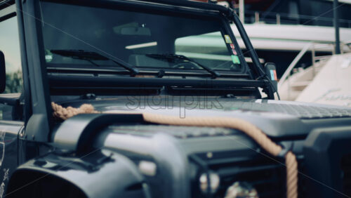 Video - Close up of a rugged off road vehicle with a thick rope across its hood