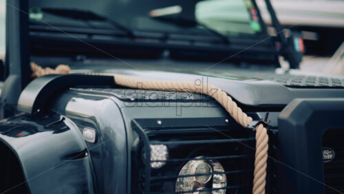 Video - Close up of a rugged off road vehicle with a thick rope across its hood