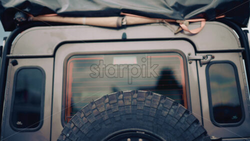 Video - Back view of an off road vehicle equipped with spare tire and roof tent