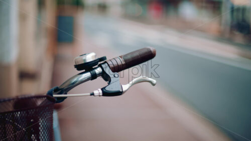 Video - Close up of a bicycle handle and bell in an empty street