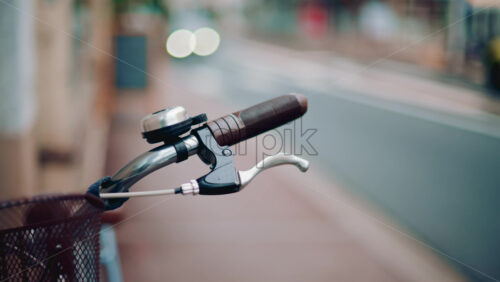 Video - Close up of a bicycle handle and bell in an empty street