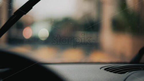 Video - View from inside a car driving in the rain, wiping the drops off the windshield