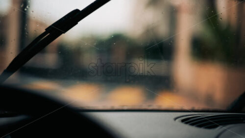 Video - View from inside a car driving in the rain, wiping the drops off the windshield
