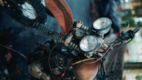 Video - Close up of a vintage rusty motorcycle parked on a city street