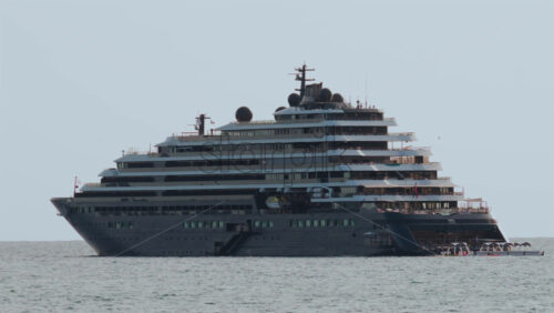 Video - Cannes, France - October 4, 2025: Massive luxury cruise ship sailing on calm sea under pale sky