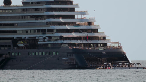 Video - Cannes, France - October 4, 2025: Massive luxury cruise ship sailing on calm sea under pale sky