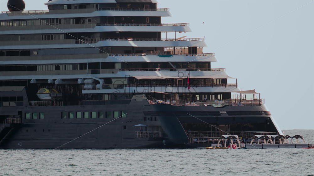 Video - Cannes, France - October 4, 2025: Massive luxury cruise ship sailing on calm sea under pale sky