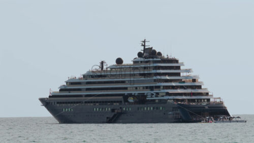 Video - Massive luxury cruise ship sailing on calm sea under pale sky