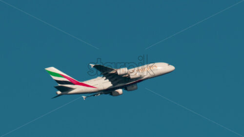 Video - Cannes, France - October 4, 2025: Emirates airplane flying across clear blue sky