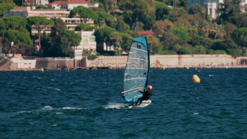 Video - Cannes, France - October 5, 2025: Athlete windsurfing on turquoise sea on a sunny day