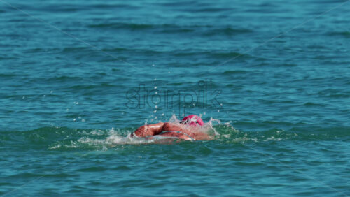 Video - Woman swimming freestyle in the calm turquoise water off the coast of Cannes, France