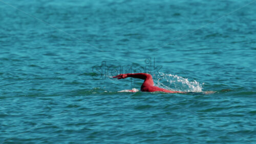 Video - Man swimming freestyle in the calm turquoise water off the coast of Cannes, France
