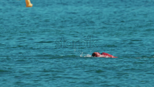 Video - Man swimming freestyle in the calm turquoise water off the coast of Cannes, France