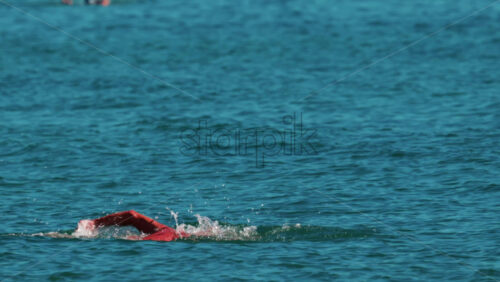 Video - Man swimming freestyle in the calm turquoise water off the coast of Cannes, France