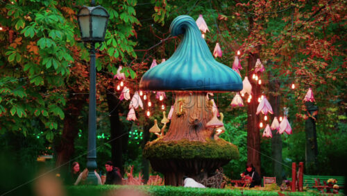 Video - Colorful fantasy style mushroom installation with glowing lights and decorative flower lamps in a forest setting
