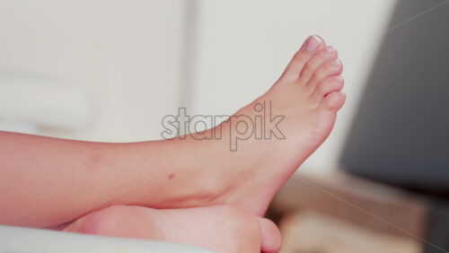 Video - Close up of a woman's feet resting on a sunbed under the sunlight on a warm day in Cannes, France