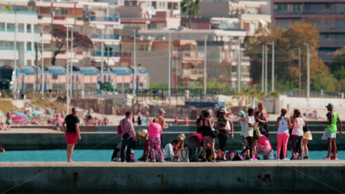 Video - Cannes, France - October 7, 2025: A group of people practicing dance or fitness on a pier by the sea on a sunny day