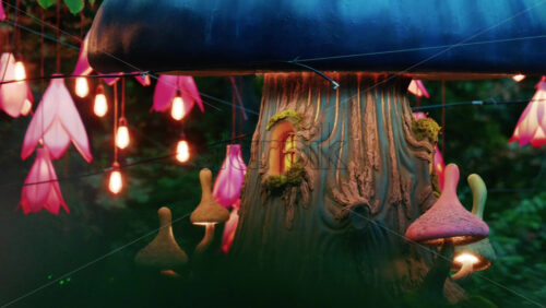 Video - Colorful fantasy style mushroom installation with glowing lights and decorative flower lamps in a forest setting