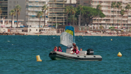 Video - Cannes, France - October 7, 2025: An instructor guides a group of children on a motorboat during a sailing lesson