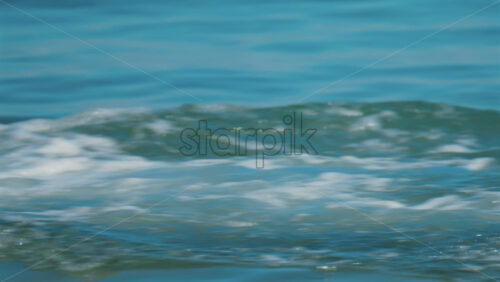Video - Cannes, France - October 8, 2025: Close up of a boy diving into the clear blue sea, creating a splash around their legs
