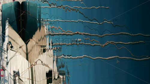 Video - Distorted reflections of yachts, ropes, and anchors on the glossy surface of a marina. Vertical