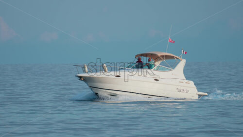 Video - Cannes, France - October 9, 2025: A sleek motor yacht glides across open waters under a clear blue sky