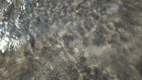 Video - Calm underwater view showing sand ripples and light reflections beneath the sea surface