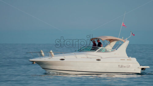 Video - Cannes, France - October 9, 2025: A sleek motor yacht glides across open waters under a clear blue sky