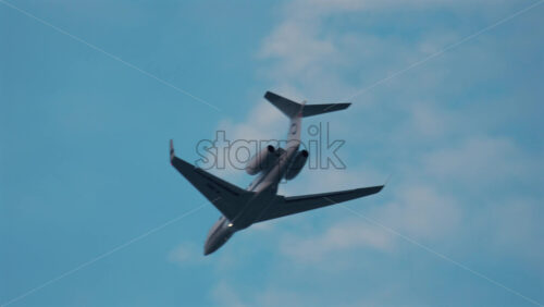 Video - Cannes, France - October 9, 2025: A passenger jet soars high in the sky with light clouds in the background