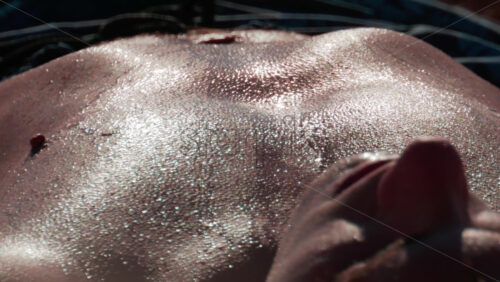 Video - Cannes, France - October 10, 2025: Close up view of sunlit skin sparkling with water droplets