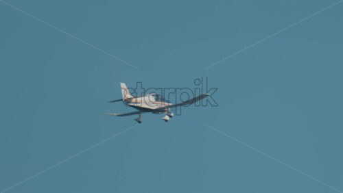 Video - Cannes, France - October 10, 2025: A small single engine aircraft glides smoothly across a bright blue sky near the French Riviera